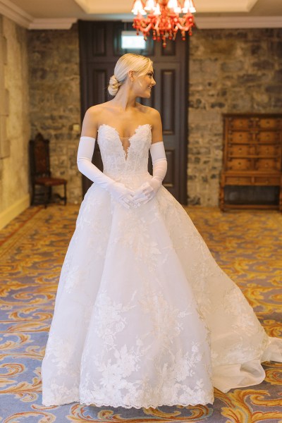 Bride stands on her own ready in bedroom