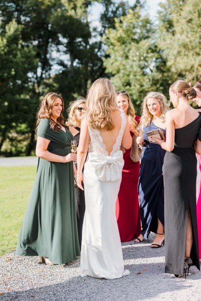 Brides detailed bow on back of dress talking to guests