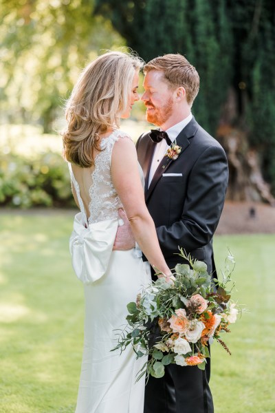 Bride and groom face each other smiling at each other