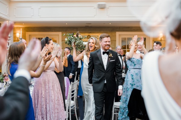 Bride and groom enter dining room guests clapping