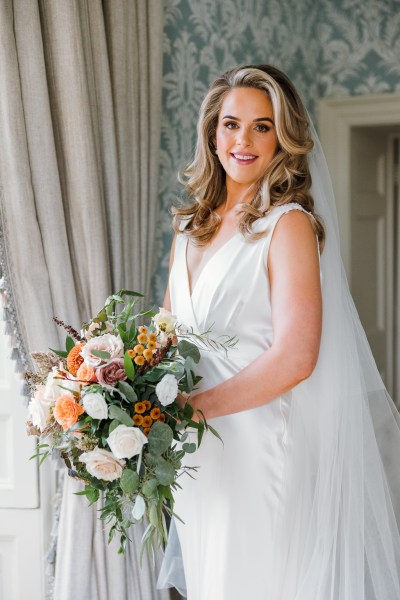 Bride holding bouquet of flowers is ready for her wedding