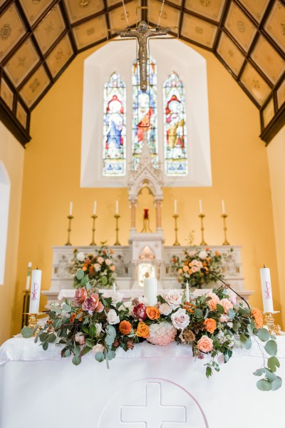 Flowers lying at alter candles detail interior church setting