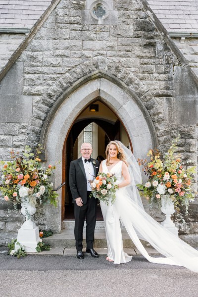 Father of the bride pose outside church exterior