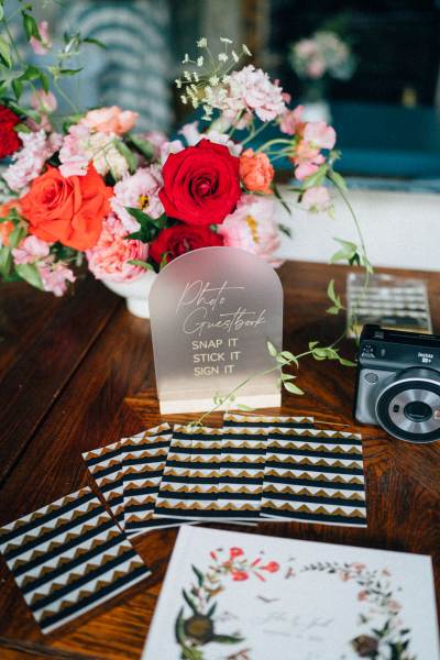 Flowers on table with polaroid camera