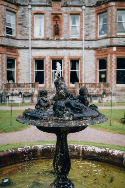 Exterior view of wedding venue house home with fountain