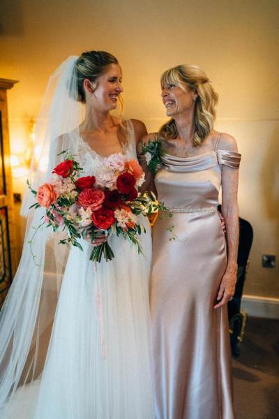 Mother and daughter pose for a picture bouquet in hand