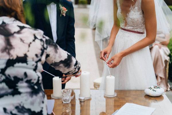 Bride and groom light the candles at ceremony