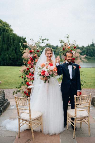 Bride and groom smile and celebrate at alter to ceremony