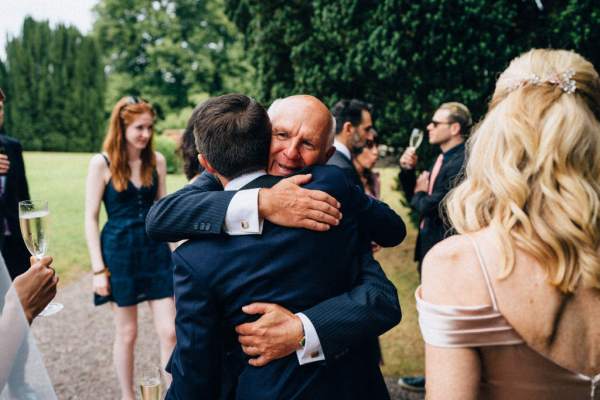 Guest hugs groom