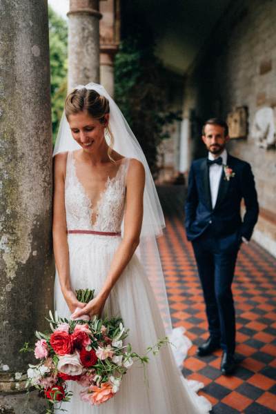 Bride and groom on checkered floor tiling exterior garden