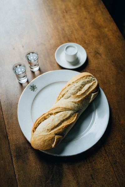 Baguette on table with two shots on table tequila/vodka