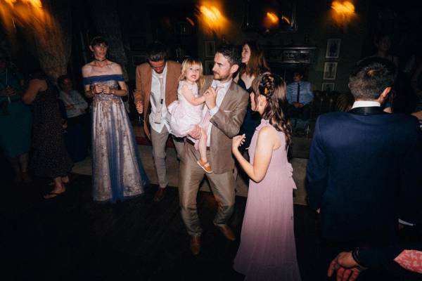 Man woman and little girl dance on dancefloor