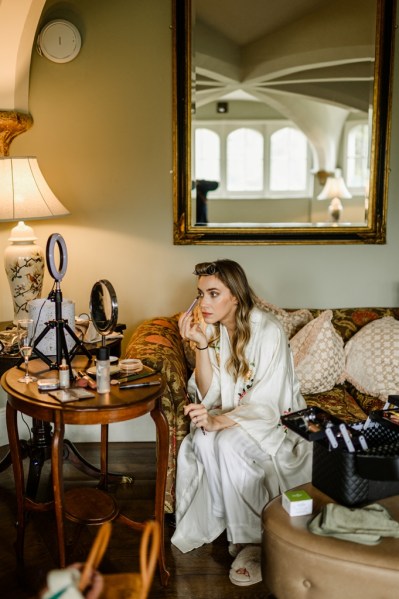 Bride putting on eyeliner doing her makeup