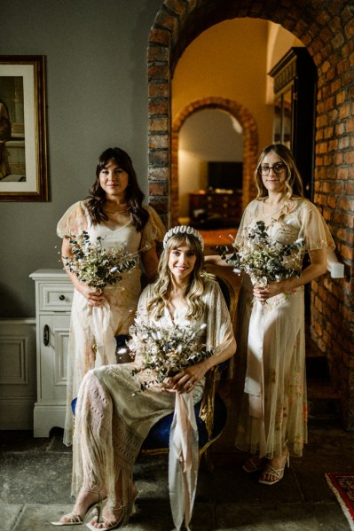 Bride and bridesmaids holding bouquet of flowers