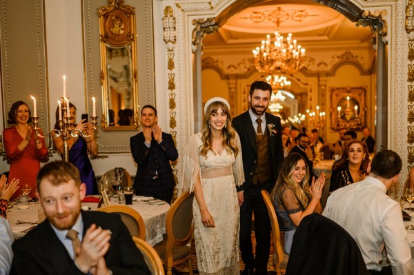 Bride and groom enter ballroom guests clapping