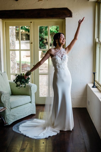 Bride hand in the air holding bouquet