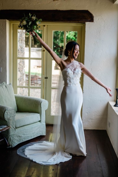 Bride hand in the air holding bouquet flowers