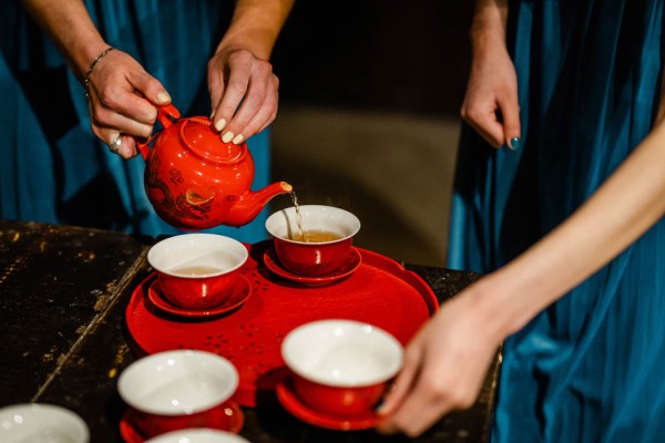 Tea is poured from red teapot