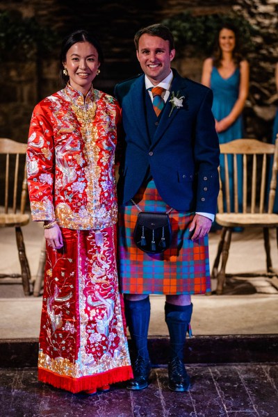 Bride and groom pose at the alter