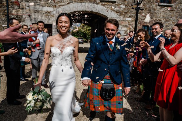 Confetti thrown on couple guests bride and groom exit church