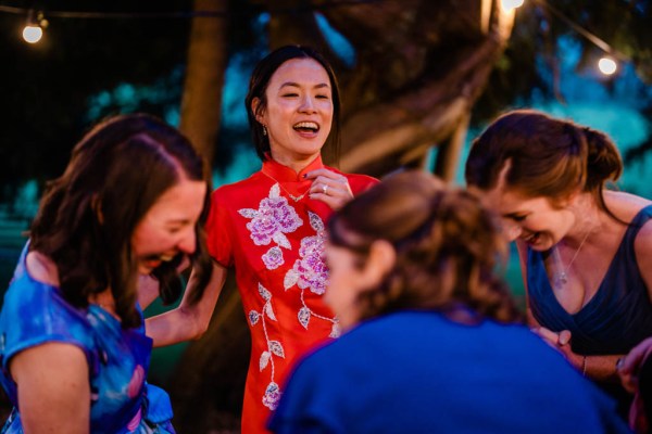 Bride celebrating dancing laughing with bridesmaids and friends