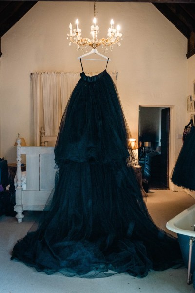 Brides black dark blue bridal gown is hanging up