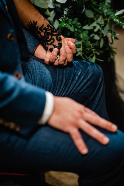 Groom hand detail holding hands with bride