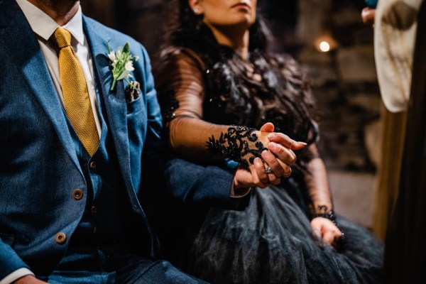 Bride and groom sitting holding hands