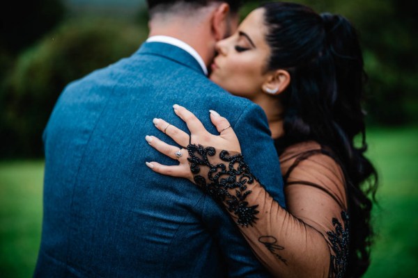 Bride kisses groom on cheek and hugs him