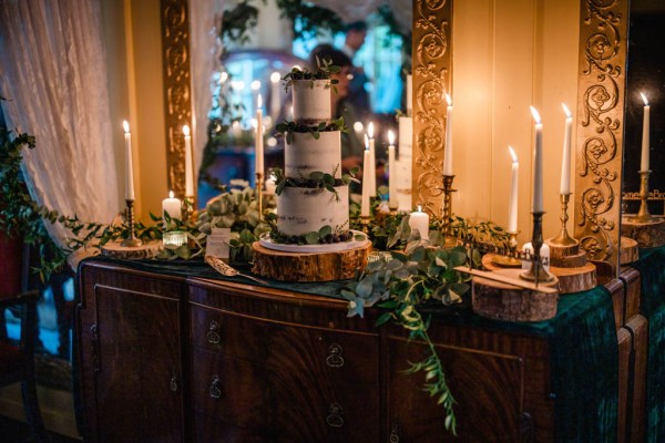 Wedding cake surrounded by candles