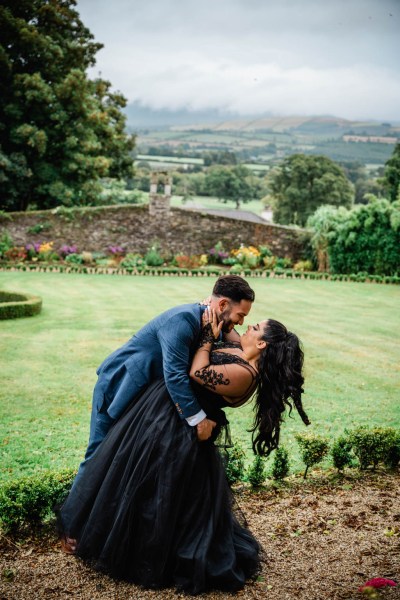 Bride and groom in garden dancing scenic background mountains