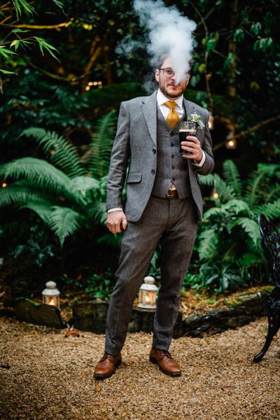 Groomsman or best man in garden holding Guinness