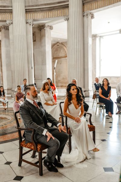 Bride and groom seated during wedding ceremony