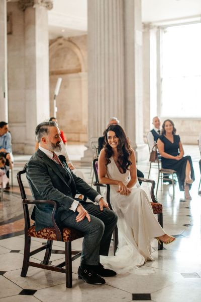 Bride and groom seated during wedding ceremony