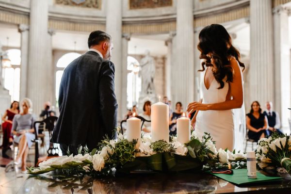 Bride and groom candles lit in front of couple