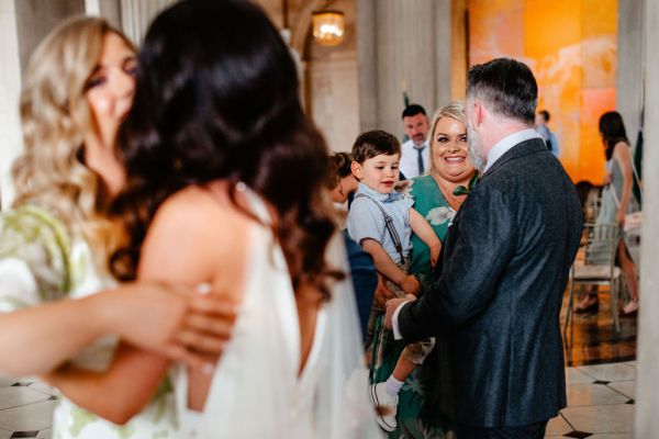 Little boy groom and bride from behind