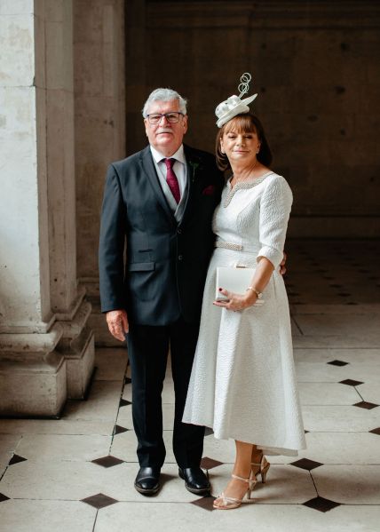 Mother and father standing on checkered floor tiles