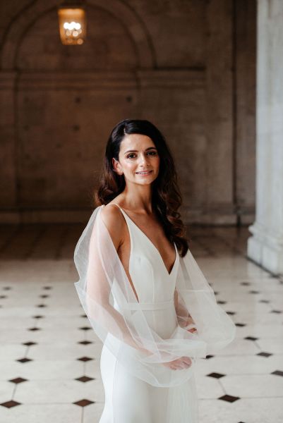 image of bride on checkered floor tiles smiling