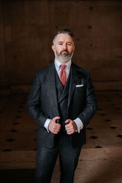 Groom stands on his own checkered floor tiles