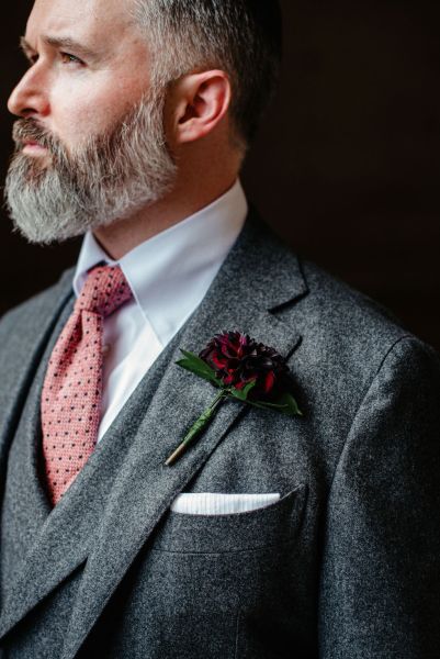 Groom stands on his own checkered floor tiles suit pocket detail