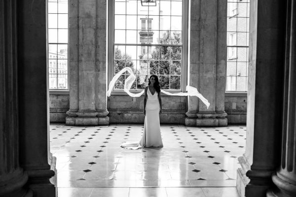 Bride dress detail on her own City Hall checkered floor large window detail