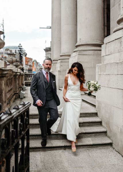 Bride and groom walking down the steps