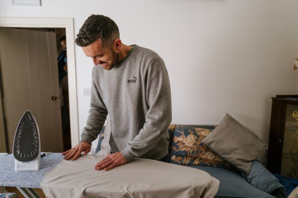 Groom irons his wedding shirt