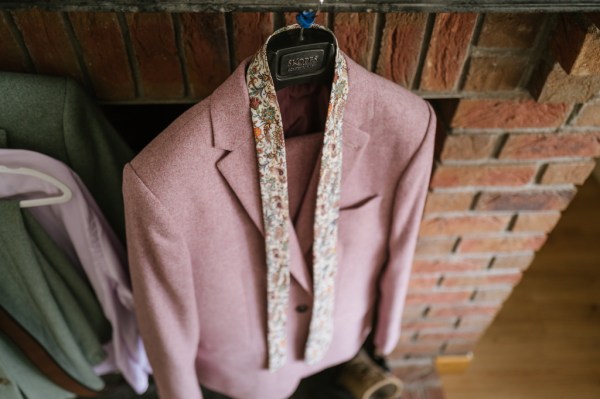 Pink purple suit for groom hanging up