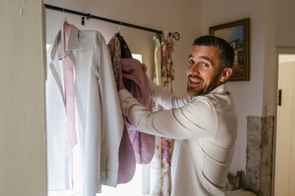 Groom picks out his suit attire gets ready