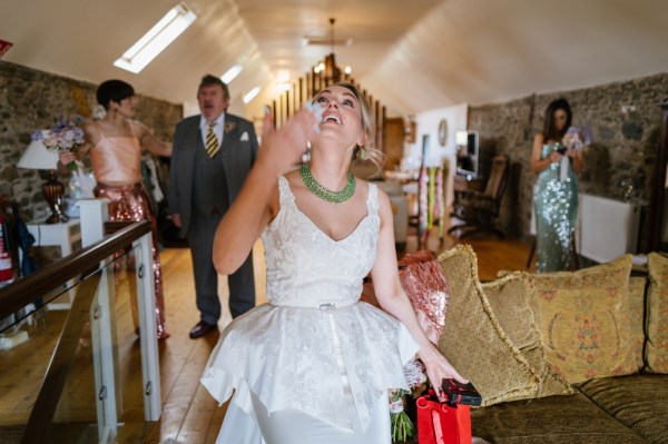 Bride smiling opening red box