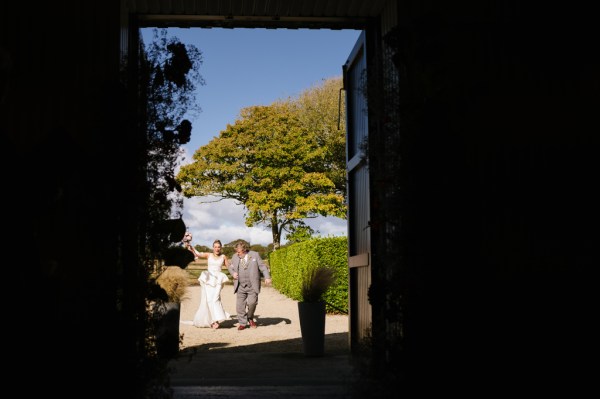 Father walks bride down the aisle towards ceremony room