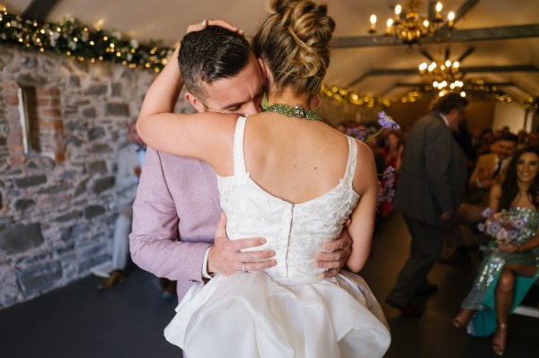 Bride and groom embrace hug