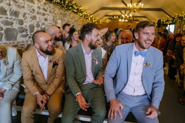 Groomsmen seated laughing