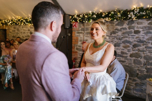 Bride and groom exchanging wedding bands rings